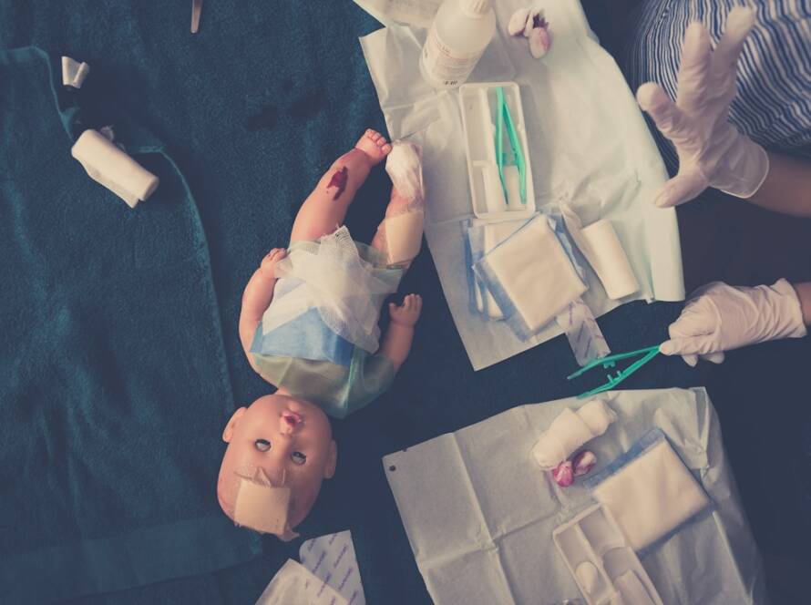 baby in white dress shirt lying on blue textile